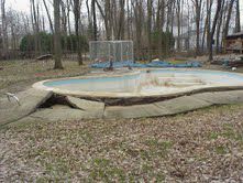 This concrete pool has floated (popped up from the ground).