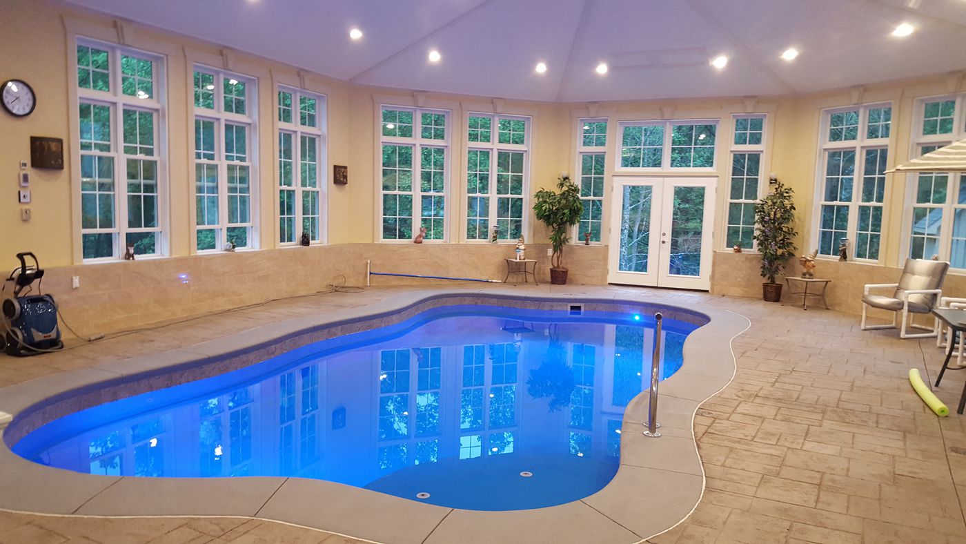 Freeform fiberglass indoor swimming pool