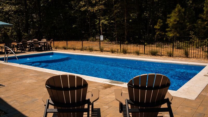inground fiberglass pool with patio