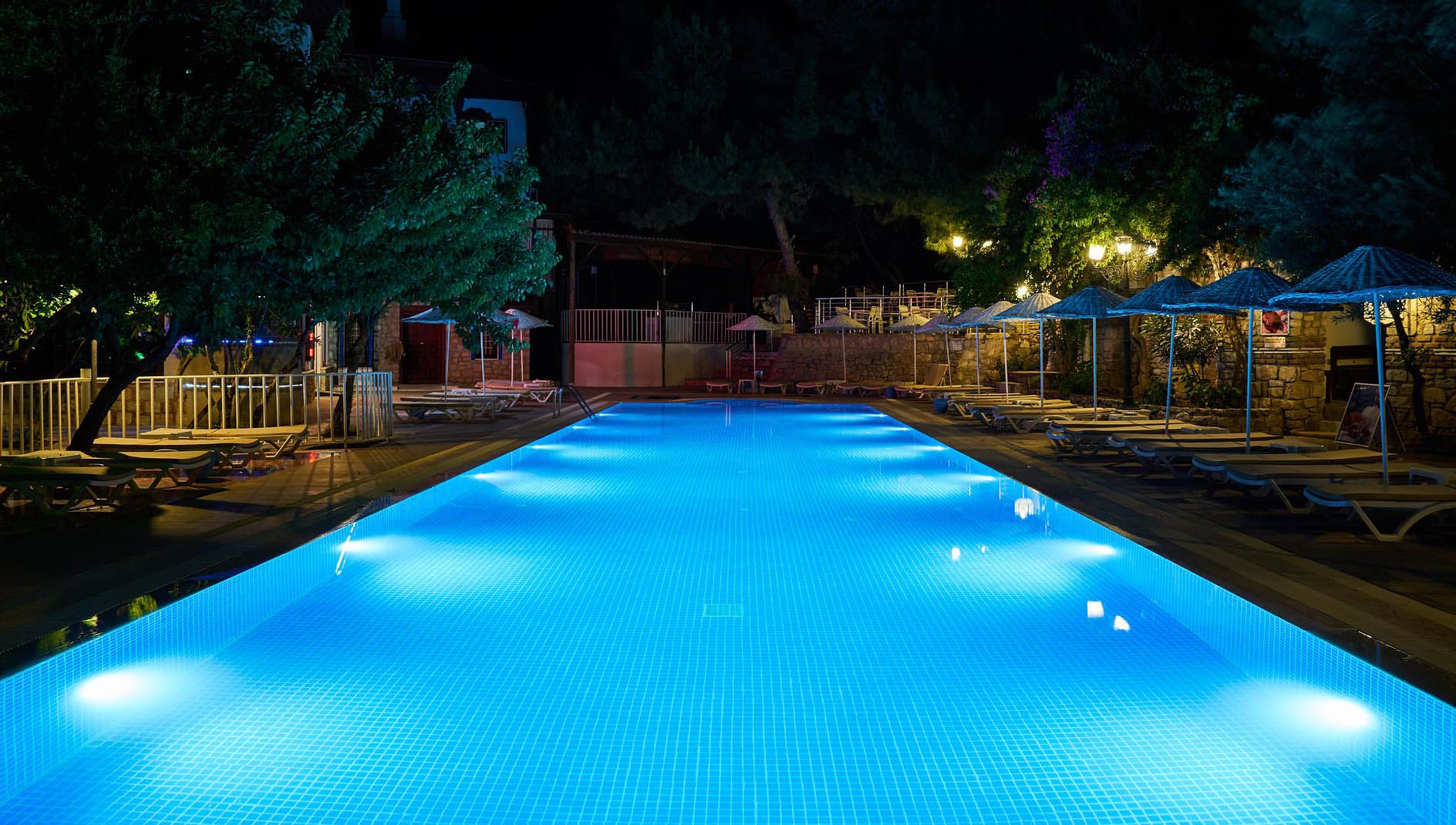 swimming pool at night - swimming pool heaters 101